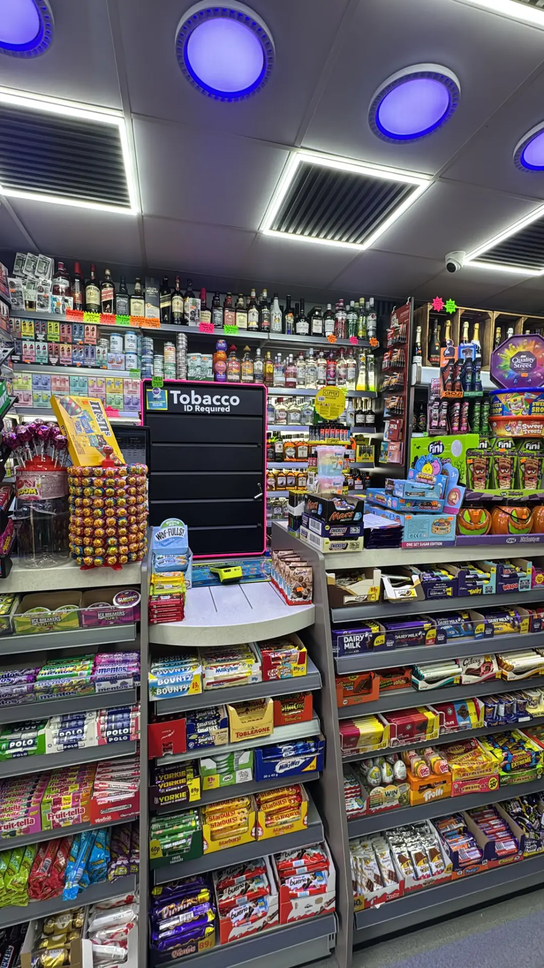 Shelves stocked with chocolate, sweets, wine and spirits